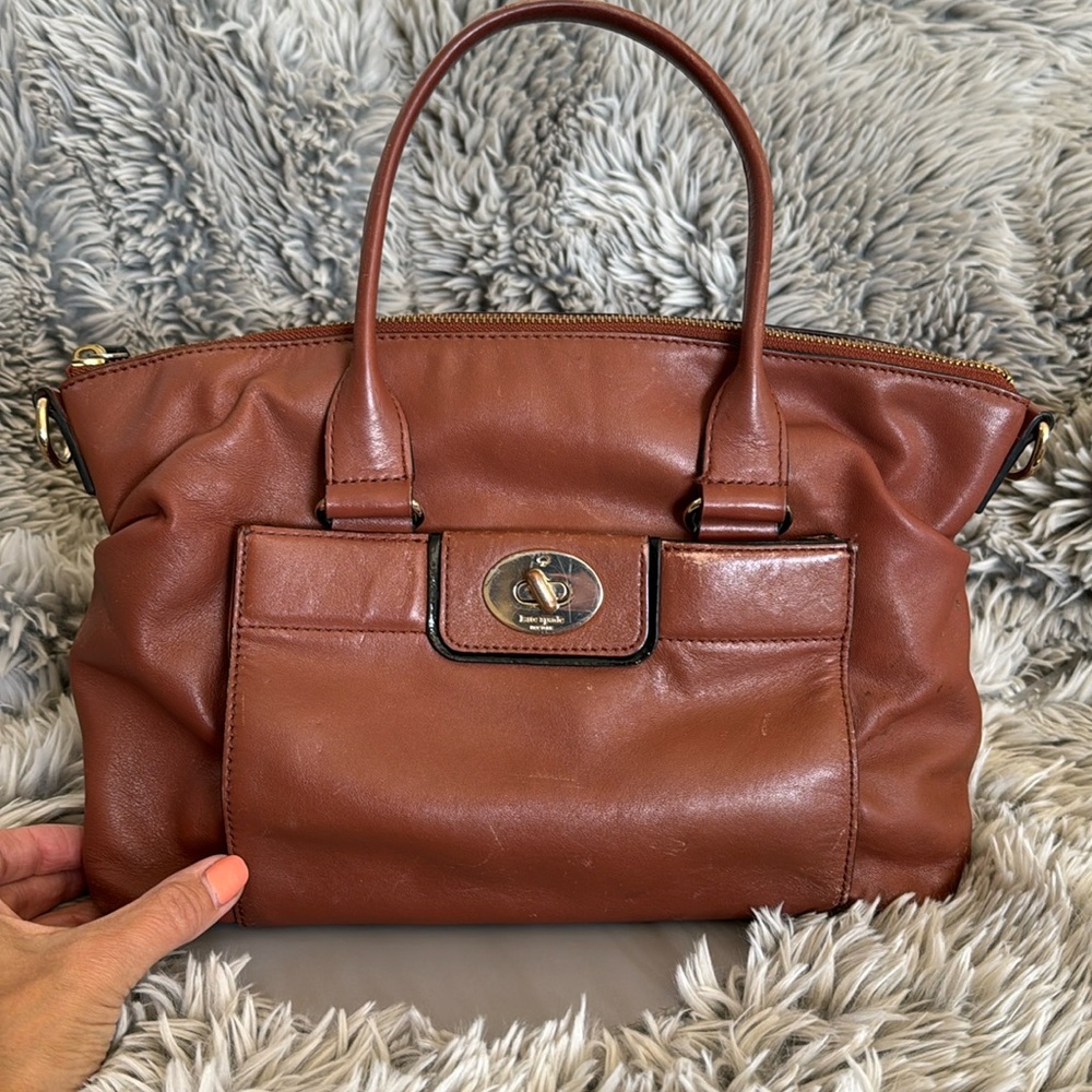 Kate Spade brown leather hand back with striped interior.